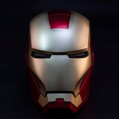 the iron man helmet is glowing in the dark