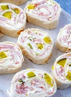 several small sandwiches with different toppings on a plate