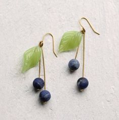 These blueberry earrings are made from vintage glass beads in a simple design with thick golden metal stalks.  The blueberries are an amazing rich, dusky matte blue colour, which looks great with the delicate opal green of the leaves. The blueberry earrings are made of vintage glass and solid brass wire, and measure exactly two inches (5cm) in length.  This piece of jewellery comes in a little gift box with a handmade tag, all ready to give or keep.We also have Cherry Earrings in a similar desig Blueberry Earrings, Silk Purse, Earrings Leaf, Cherry Earrings, Fruit Earrings, Handmade Tags, Earring Tree, Funky Jewelry, Blue Colour