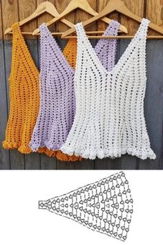 three crocheted vests hanging on a wooden hanger next to each other