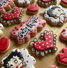 decorated cookies are arranged on a wooden table