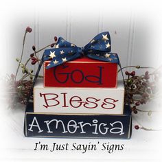 a stack of blocks with the words god, bless america and i'm just saying signs