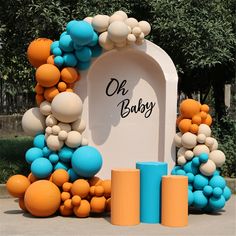 an arch decorated with balloons for a baby shower