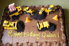 a birthday cake with construction trucks and dirt on it that says happy birthday quimin