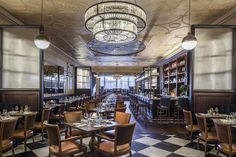 a restaurant with checkered flooring and chandeliers