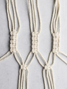 three ropes tied together on a white surface