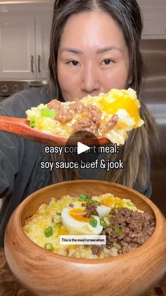 a woman is holding up a spoon with food in it