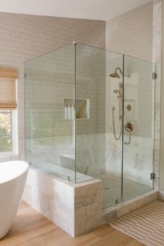 a bathroom with a bathtub, sink and window