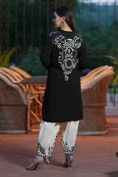 Black cotton kurta with white floral and thread embroidery. Comes with dhoti pant.
Components: 2
Pattern: Embroidered
Type Of Work: Floral, Thread
Neckline: V Neck
Sleeve Type: Full
Fabric: Cotton
Color: Black
Other Details: 
Length:
Kurta: 38 inches
Pant: 40 inches
Occasion: Sangeet - Aza Fashions Traditional Dabka Pant Set For Eid, Traditional Pant Set With Dabka Work, Unstitched Chikankari Embroidery Palazzo Set For Traditional Ceremonies, Traditional Straight Kurta Pant Set With Dabka, Traditional Pant Set With Dabka And Straight Kurta, Traditional Pant Set With Dabka On Straight Kurta, Traditional Dabka Pant Set With Straight Kurta, Traditional Pant Set With Dabka And Traditional Drape, Traditional Kurta With Intricate Embroidery In Cambric