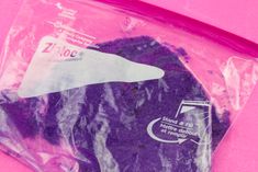 there is a plastic bag with purple stuff in it