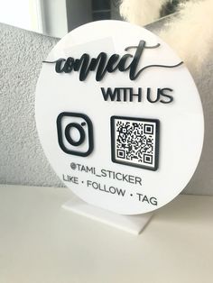 a white sticker with the words connect with us and a qr code on it