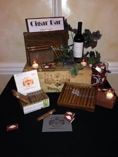 an assortment of cigars and bottles on a table