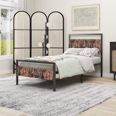 a bedroom with an iron bed frame and headboard made from wood, metal and fabric