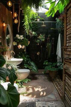 an outdoor bathroom with plants and lights on the ceiling, along with a sink in the middle