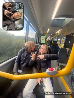 two women are sitting on a bus and one is holding her hand out to the side