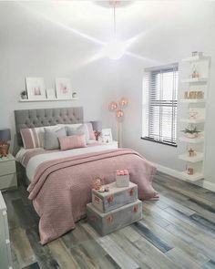 a bedroom decorated in pink and grey tones