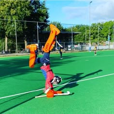 a person doing a handstand on some skis