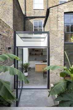 an open air kitchen and living room in a brick building