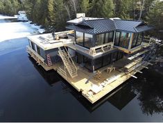 an aerial view of a house on water with stairs leading up to the upper level