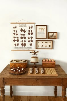 a wooden table topped with cakes and pastries on top of a hard wood floor