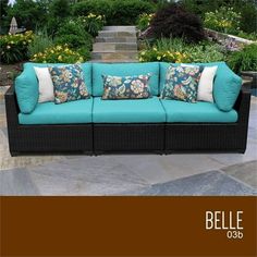 a blue couch sitting on top of a stone patio