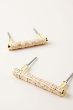 two pairs of gold and white hair pins