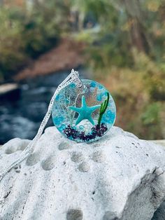 a starfish on top of a rock with water in the background