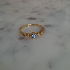 Marked 14k On The Inside Of The Band. Blue Topaz Center Stone With Four Tiny Diamonds. Delicate And Dainty. Timeless And Classic. Perfect For Everyday Wear. Great For Wearing Alone Or Stacking With Other Rings. Only Worn A Few Times And In Great Condition. Elegant And Chic. So Pretty! Tiny Diamond, 14k Gold Ring, Womens Jewelry Rings, So Pretty, Blue Gold, Blue Topaz, Gold Ring, Topaz, Gold Rings