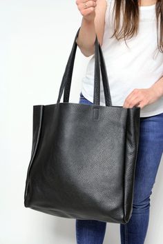 "Leather Tote Bag for Women, Black Leather Purse This black large tote bag is made from high quality italian leather. Spacious interior provides room for all the daily essentials and more. There is an inside zippered pocket. This bag is perfect as your everyday bag, which can fit an IPAD, laptop, A4 files, books, magazines, cosmetic bag as well as many accessories. * Width: 40 cm (15.7\") * Height: 40 cm (15.7\") * Width: 11 cm (4.3\") * Inside pocket: 30 x 21 cm x (11.8\" x 8.3\") * Handle Drop Black Satchel With Double Handle And Smooth Grain, Black Satchel With Smooth Grain And Double Handle, Everyday Black Shoulder Bag With Smooth Grain, Everyday Black Smooth Grain Shoulder Bag, Black Smooth Grain Rectangular Shoulder Bag, Everyday Black Bags With Smooth Grain, Everyday Black Smooth Grain Bag, Black Smooth Grain Tote Bag, Black Smooth Grain Shoulder Bag For Daily Use