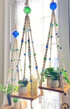 two hanging planters with beads and plants in them