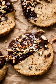 several cookies with chocolate and nuts on top