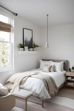 a bedroom with white walls and carpeted flooring, a bed covered in beige blankets