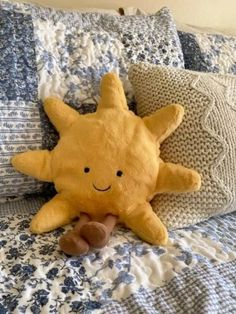 a yellow stuffed animal laying on top of a bed