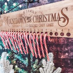 candy canes are lined up in front of a sign for the town of christmas