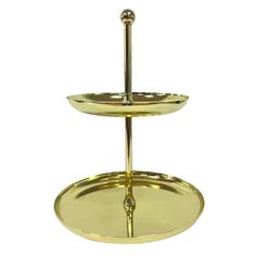 two tiered brass plate with handles on each side and a hook in the middle