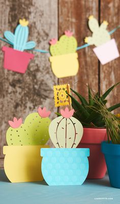 paper cactuses and succulents are sitting on the table