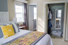 a bedroom with a bed, mirror and closet