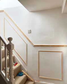 a stair case with wood trim on the wall