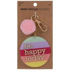 a keychain with a pom - pom on it that says be happy today