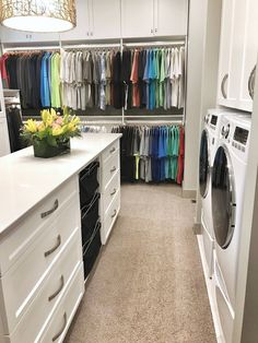 a laundry room filled with lots of clothes next to a washer and dryer