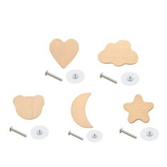 six wooden shapes with metal pins and clips on white background, including a heart, star, moon, and crescent