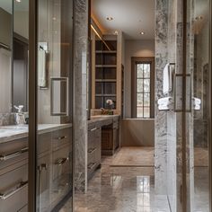 a large bathroom with marble floors and walls