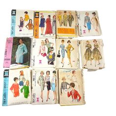 nine vintage clothing patterns from the 1950's and 1960s's are on display