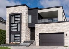 a modern house with two garages and steps leading up to the front door