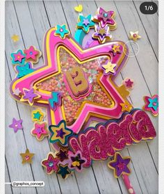 a wooden table topped with lots of colorful cookies