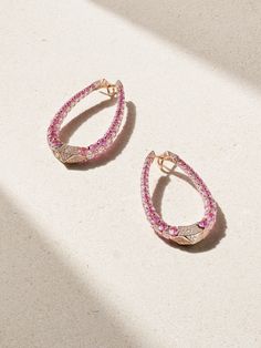 Boghossian's earrings are crafted using the house's 'Merveilles' technique, which makes the settings nearly invisible, allowing the stones to sparkle beautifully. Cast from 18-karat rose gold, they have an elongated hoop silhouette encrusted with 11.16-carats of pink sapphires and 9.38-carats of shimmering diamonds. Luxury Oval Diamond Earrings, Luxury Oval Diamond Earrings With Pave Setting, Luxury Pear-shaped Earrings With Pave Setting, Luxury Pink Diamond Earrings Brilliant Cut, Luxury Pink Brilliant Cut Diamond Earrings, Luxury Rose Gold Oval Earrings, Luxury Pink Diamond Earrings, Pink Formal Hoop Earrings In Fine Jewelry Style, Pink Hoop Earrings For Formal Occasions