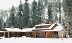 a log cabin in the snow with pine trees