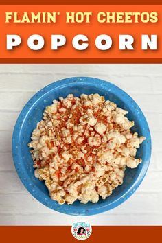 a blue bowl filled with popcorn on top of a table