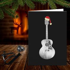 a christmas card with an image of a guitar on it and a santa's hat