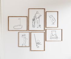 six framed drawings hang on the wall above a bed